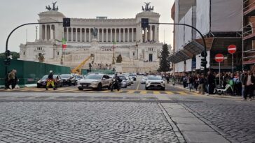 Traffico e pedoni davanti all’Altare della Patria a Roma con deviazioni e senso unico attivi.