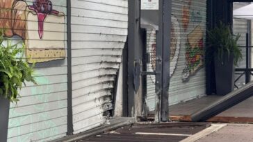 Serranda di un bar ad Acilia deformata e distrutta dopo l’esplosione di un ordigno nella notte.